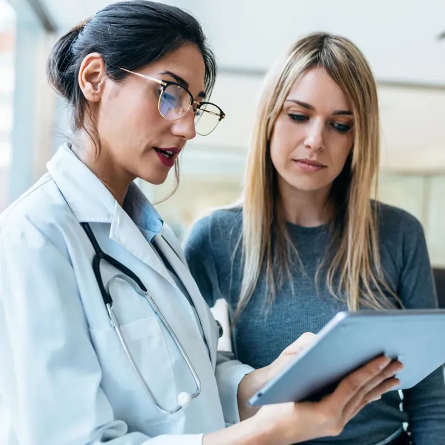 Women's health nurse practitioner reviewing test results with female patient